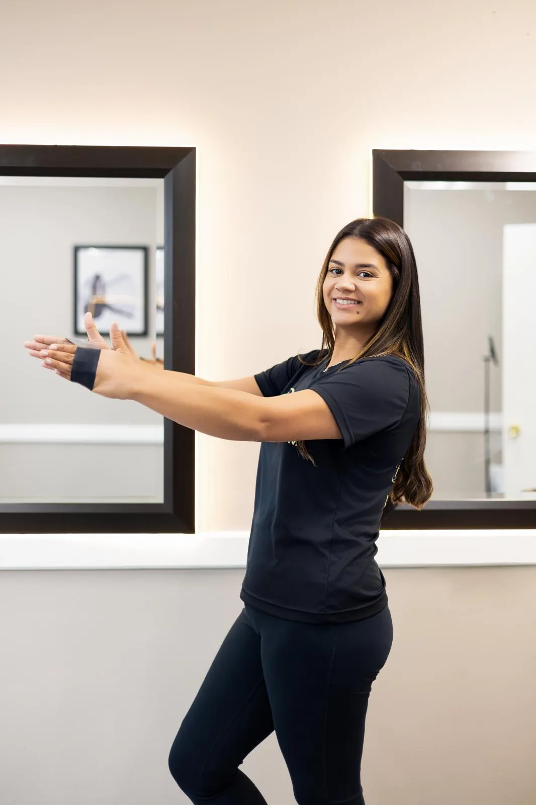 Instructor showing a standing arm exercise with a resistance band
