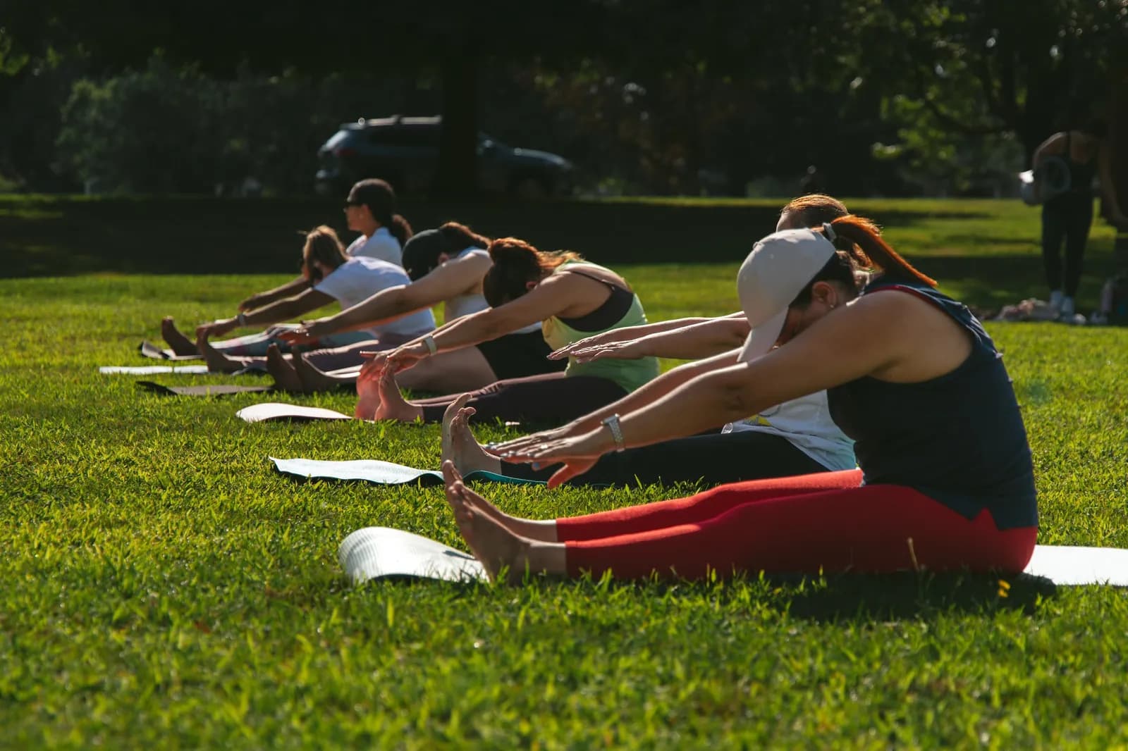 Small group Mat Pilates class practicing outdoors in Greater Lowell