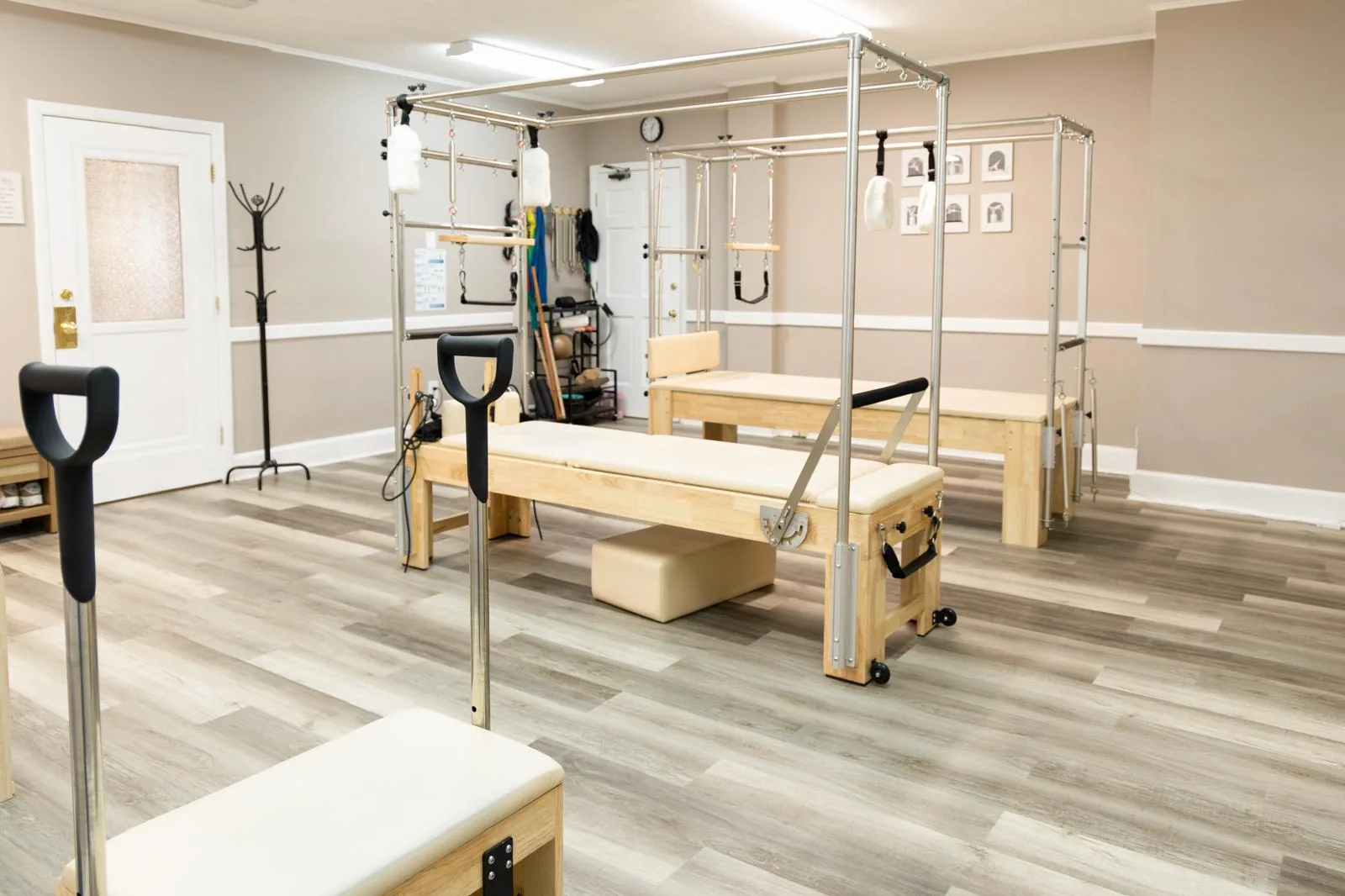 Bright Pilates room with Cadillacs and a Wunda Chair at Inspire Pilates Studio