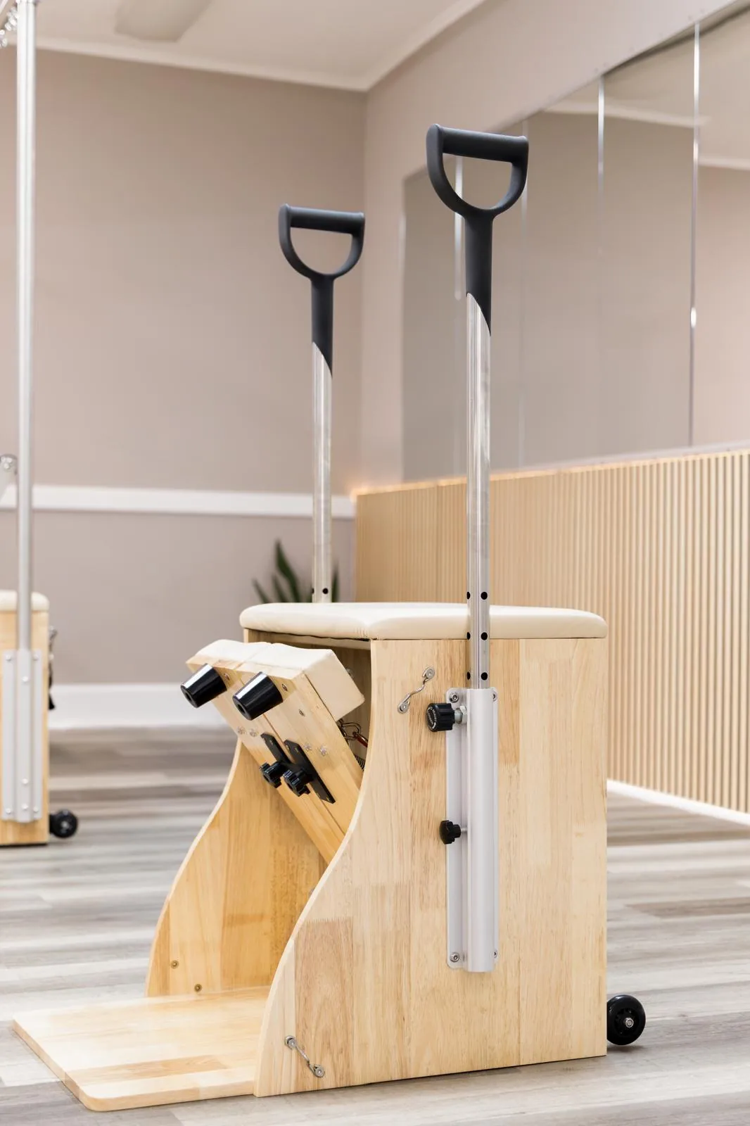 Wooden Wunda Chair with black handles on the studio floor
